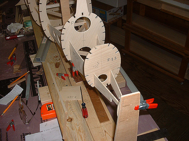 Holes drilled thru the 2 rear bulkheads for wires and rudder servo rod. Also to reduced weight.
